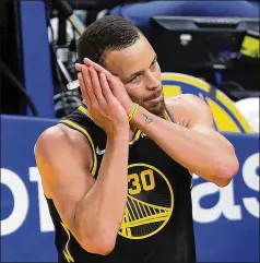  ?? CARLOS AVILA GONZALEZ/SAN FRANCISCO CHRONICLE VIA ASSOCIATED PRESS ?? Warriors guard Stephen Curry makes a sleeping gesture late in the second half of their series-clinching 102-98 victory over the Nuggets in Game 5 on Wednesday. Curry had a team-high 30 points, including 11 during the fourth quarter.