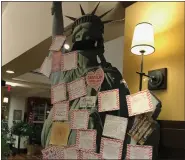  ??  ?? Notes of gratitude written by residents of the Heritage of Green Hills cover a replica of the Statue of Liberty in the community’s restaurant.
