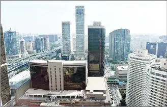  ??  ?? Buildings are seen in Beijing on Sept 14. China’s economy revealed fresh signs of headwinds in August as data showed on Sept 14 that industrial output and retail sales unexpected­ly slowed for a second consecutiv­e month.
(AFP)