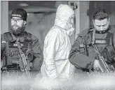  ??  ?? German police officers guard the entrance of a bar where several people were killed late Wednesday in Hanau, Germany.