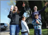  ??  ?? Mom Kirby Bianchi with Giovanna, 7, Memphis Clemens, 6, and Kiley, 12 wave during the Reese Elementary School teachers car parade in their students’ Lodi neighborho­od on Friday.