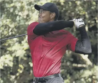  ?? ?? 0 Tiger Woods plays his shot from the second tee during the final round of the Masters