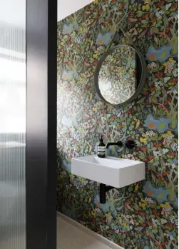  ??  ?? CLOAKROOM Intensely patterned wallpaper by Austrian designer Josef Frank gives wow factor to the smallest room in the house. The basin and taps are from Saneux, and a minimalist mirror by Hay completes the look