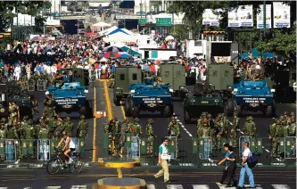  ??  ?? CARACAS: In this Feb 14, 2004 file photo, the military creates a perimeter at a government-subsidized food market in the Venezuelan capital. The late President Hugo Chavez began handing the military control over food, and the wider economy, following...