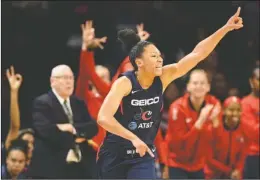  ?? The Associated Press ?? CHEERFUL LEADER: Washington Mystics forward Aerial Powers reacts during the first half of Wednesday’s game against the Seattle Storm in Washington.