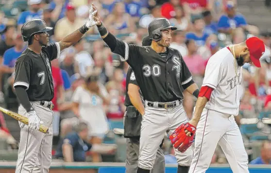  ??  ?? Nicky Delmonico ( 30) — high- fiving teammate Tim Anderson in the first inning — became the first Sox rookie to begin his career by reaching base in his first 13 games. | AP