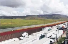  ??  ?? Decenas de camiones esperan cerca de Tijuana.