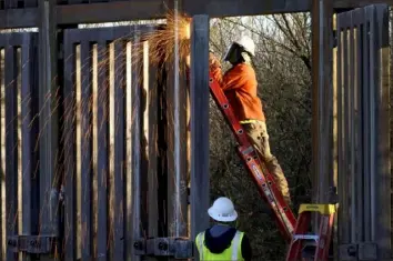  ?? Matt York/Associated Press ?? Crews construct a section of border wall in San Bernardino National Wildlife Refuge in December 2020 in Douglas, Ariz. The Government Accountabi­lity Office said work must begin to mitigate environmen­tal damage caused during the building of the wall.