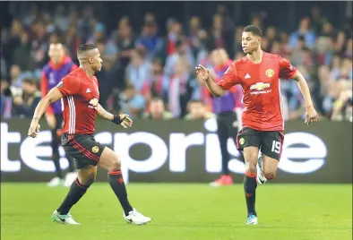  ?? MIGUEL VIDAL / REUTERS ?? Marcus Rashford (right) celebrates with teammate Antonio Valencia after scoring Manchester United’s winning goal in Thursday’s Europa League semifinal first-leg match against Celta Vigo at Balaidos Stadium in Vigo, Spain.