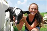  ?? LISA MITCHELL - DIGITAL FIRST MEDIA ?? The Lesher family of Bernville received the 2018 Berks County Outstandin­g Farm Family, sponsored by the Berks County Grange and the Reading Fair. Pictured on the family dairy farm is Olivia Lesher, 16, with one of her calves.