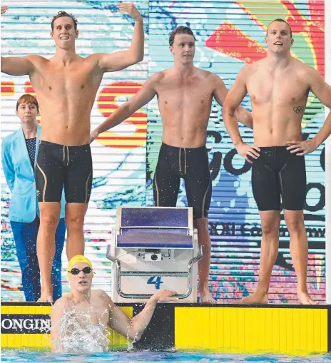  ??  ?? Golden boys (standing from left) Alexander Graham, Elijah Winnington, Kyle Chalmers and Mack Horton (in pool) after winning the men’s 4x200m freestyle relay at the Commonweal­th Games last week.