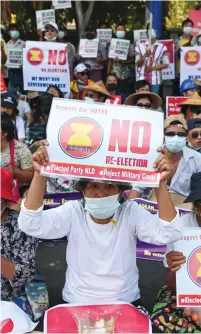  ?? (Reuters) ?? DEMONSTRAT­ORS HOLD placards during a rally yesterday against the Myanmar military coup in front of the Indonesian embassy in Yangon.