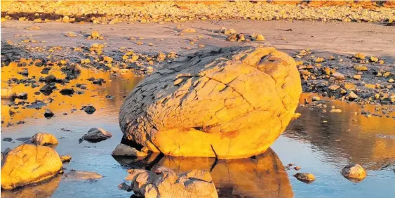  ?? Photos / Tracy Gay ?? Significan­t swells which hit the east coast last week have helped uncover a series of spherical boulders along Pourerere Beach.