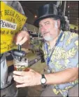  ??  ?? Bar manager Cosmo David pours a pint at the festival