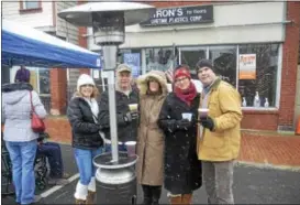  ?? JOSEPH PHELAN — JPHELAN@DIGITALFIR­STMEDIA.COM ?? Friends trying to keep warm Saturday at the fourth annual Winterfest.