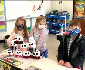  ?? ?? Left to right, Danny D’Antonio, Hanna Blosinski and Diana D’Antonio, Glenwood School first-grade students in Karen Maher’s class, decorated toilet paper rolls as snowmen, and donated face masks to local families in need, as part of the school’s Martin Luther King, Jr. Day of Service earlier this month.