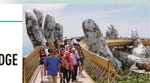  ?? REUTERS PIC ?? Visitors walking along the Cau Vang in the Ba Na Hills near Da Nang City yesterday.