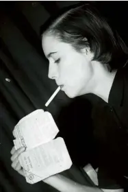  ??  ?? UP IN SMOKE Daily
Express columnist Drusilla Beyfus (below left) sets light to a clothing ration book in March 1949