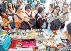  ?? SUPPLIED ?? Students look at books on sale at the Khmer Literature Festival in 2019 in Battambang.