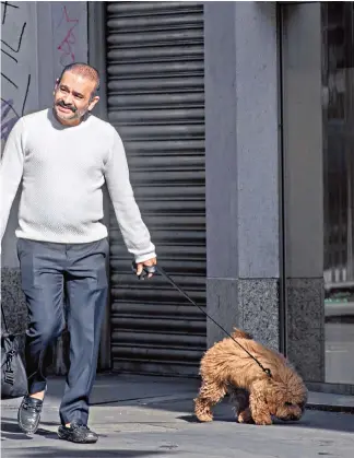  ?? Photograph­y: Eddie Mulholland for the Telegraph and Julian Simmonds for the Telegraph ?? A casual Mr Modi walks his dog in London, above; Indian opposition supporters shout slogans against him in New Delhi, above right; and meeting Prince Charles, right