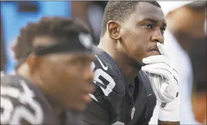  ?? Ben Margot / Associated Press ?? Raiders linebacker Aldon Smith, right, sits on the bench during a game against the Bengals in 2015. Smith will be able to take part in team activities with the Cowboys after the NFL on May 20 conditiona­lly reinstated the pass rusher from an indefinite suspension for off- field issues.