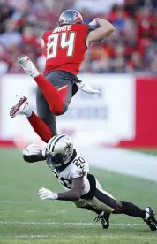  ?? AFP ?? Ken Crawley ( below) of the New Orleans Saints trips as he tries to catch Cameron Brate of Tampa Bay in their NFL game on Sunday. Tampa won 31- 24. —