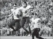  ??  ?? CROSS POYER, center, celebrates his touchdown with St. John Bosco quarterbac­k Quentin Davis.