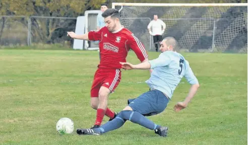  ??  ?? Glantraeth match-winner Andy Barker (red) takes on Penrhyndeu­draeth at Maes-y-Parc last Saturday. Picture: ALED JONES