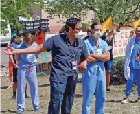  ?? ASSOCIATED PRESS FILE PHOTO ?? Medical staff from Rehoboth McKinley Christian Hospital, including Caleb Lauber, center, hold a protest May 8 over working conditions and depleted staff in Gallup.