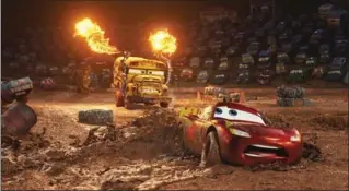  ?? PIXAR ?? Lightning McQueen, voiced by Owen Wilson, foreground, has to fight to stay alive against insane school bus Miss Fritter (Lea DeLaria) at the demolition derby in “Cars 3.”