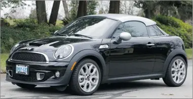  ??  ?? The 2012 Mini Cooper S Coupe is a sporty two- seater that looks terrific and handles like a go kart.