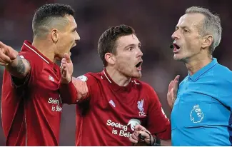  ?? GETTY IMAGES ?? Officially angry: Lovren and Robertson harangue Martin Atkinson