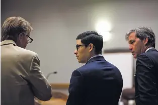  ??  ?? ABOVE: Tai Chan, center, talks with attorneys Tom Clark, left, and John Day during a hearing Thursday in Las Cruces. Chan faces a voluntary manslaught­er charge in a third trial for the killing of fellow Santa Fe County Deputy Jeremy Martin in 2014.