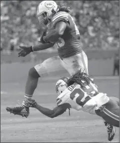  ?? The Associated Press ?? NO STOPPING HIM: Buffalo cornerback Ronald Darby (28) attempts to tackle Miami running back Jay Ajayi (23) during the second half of the Dolphins’ 28-25 victory Sunday.