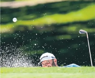  ?? DAVID J. PHILLIP THE ASSOCIATED PRESS ?? Dustin Johnson hits out of a bunker on the fifth hole during the first round of the Charles Schwab Challenge, the PGA Tour’s first event in three months. Johnson shot 71, leaving him tied for 94th.