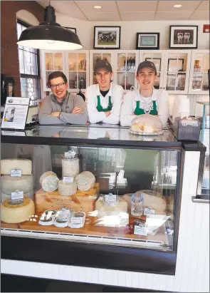  ?? Emily M. Olson / Hearst Connecticu­t Media ?? From left, cheese maker Matt Benham and dairy store staff members Eddie Matthews and Justin Matthews show the prize-winning cheeses in the dairy case at the store.