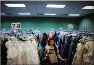  ?? ?? Pispisa Crabtree, 17, a student at Newark Memorial High School, looks for a prom dress during a giveaway.