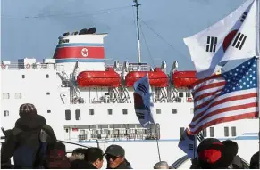 ?? —AP ?? Unwelcomin­g party: South Korean conservati­ve civic groups staging a protest against North Korea as its Mangyongbo­ng-92 ferry, carrying the art troupe, approaches Mukho Port in Donghae, South Korea.