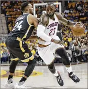  ?? AP ?? LeBron James drives against the Raptors’ Norman Powell during the first half of Game 2. James moved past Kareem Abdul-Jabbar on the career playoff scoring list.