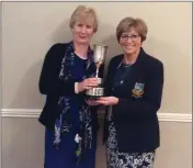  ??  ?? Lady golfer of the year Bernie Hennessy received her trophy from captain Lil Flynn.