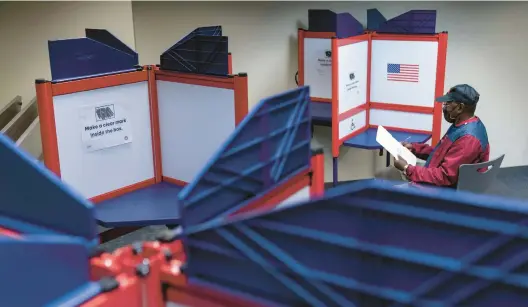  ?? ANDREW HARNIK/AP 2022 ?? A voter fills out his ballot at an early voting location in Alexandria, Virginia. In 2024, the U.S., the European Union, India and Indonesia will all hold general elections.