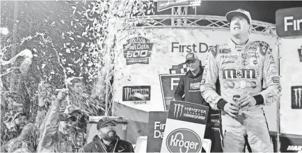  ?? MICHAEL SHROYER, USA TODAY SPORTS ?? Kyle Busch celebrates Sunday after winning the First Data 500 at Martinsvil­le Speedway to ensure advancemen­t to the four-driver title-eligible field for the Monster Energy NASCAR Cup Series playoff final.