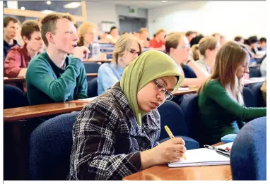  ??  ?? Students who sit in the front of the lecture hall are at an advantage as they can see the board better and won’t be tempted to goof off.