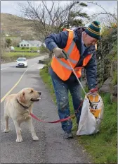  ?? John McCarthy, with Bailey the dog helping to sniff out litter, in Milltown. ??