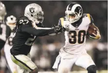  ?? Scott Strazzante / The Chronicle ?? The Raiders’ Reggie Nelson tries to stop the Rams’ Todd Gurley in Week 1. Nelson’s playing time has waned recently.