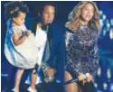  ??  ?? Jay-Z presents the Video Vanguard Award to his wife as he holds Blue Ivy at the MTV Video Music Awards in 2014.