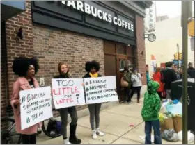  ?? THE ASSOCIATED PRESS ?? Protesters gather Sunday outside a Starbucks in Philadelph­ia where two black men were arrested Thursday after Starbucks employees called police to say the men were trespassin­g. The arrest prompted accusation­s of racism on social media. Starbucks CEO...