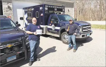  ?? Contribute­d photo ?? Micah Welintukon­is, of Coventry, has been delivering 300,000 face masks purchased by anonymous donors to police and fire stations, hospitals and other locations to help avoid the spread of coronaviru­s. East Hampton Ambulance Associatio­n members received their masks Thursday.