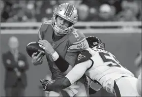  ?? PAUL SANCYA/AP PHOTO ?? Los Angeles Rams inside linebacker Cory Littleton (58) sacks Detroit Lions quarterbac­k Matthew Stafford (9) jarring the ball loose during Sunday’s game.