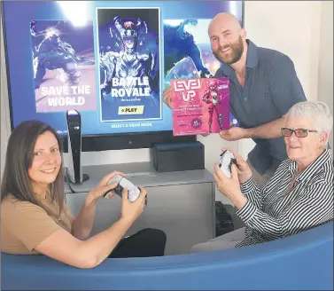  ?? Picture: PAUL CARRACHER ?? Horsham online game enthusiast Beau Ladlow shows Lou Barnett, left, and June Crabtree his plans for a Wimmera-wide Fortnite competitio­n.